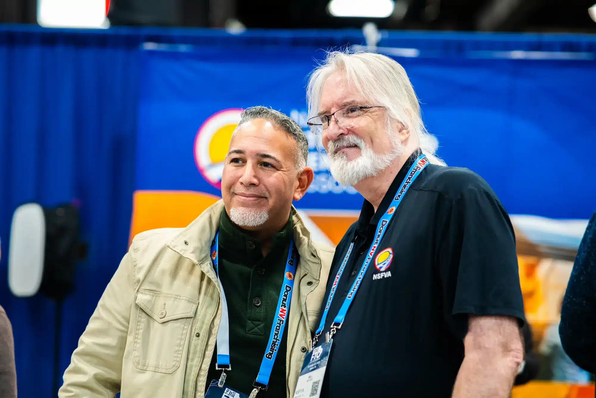 2 men smiling at the camera