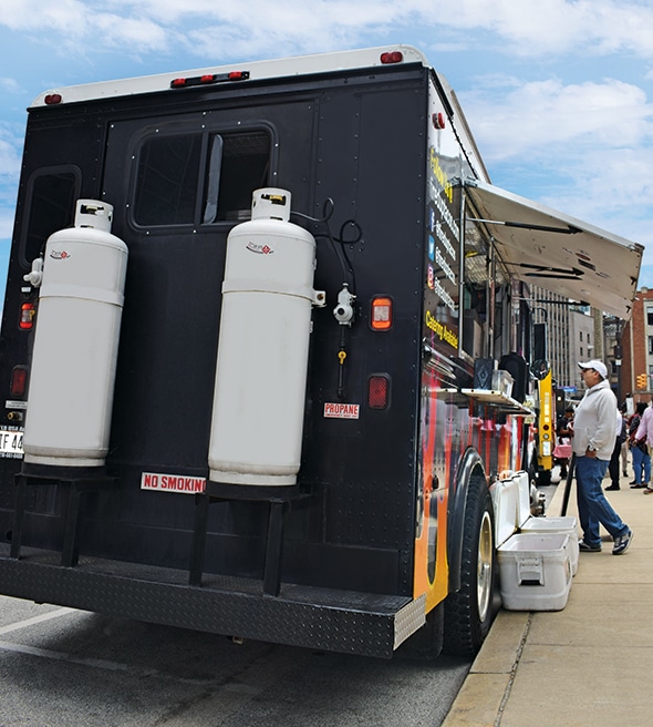 Food Truck with 2 propane tank on the back of it